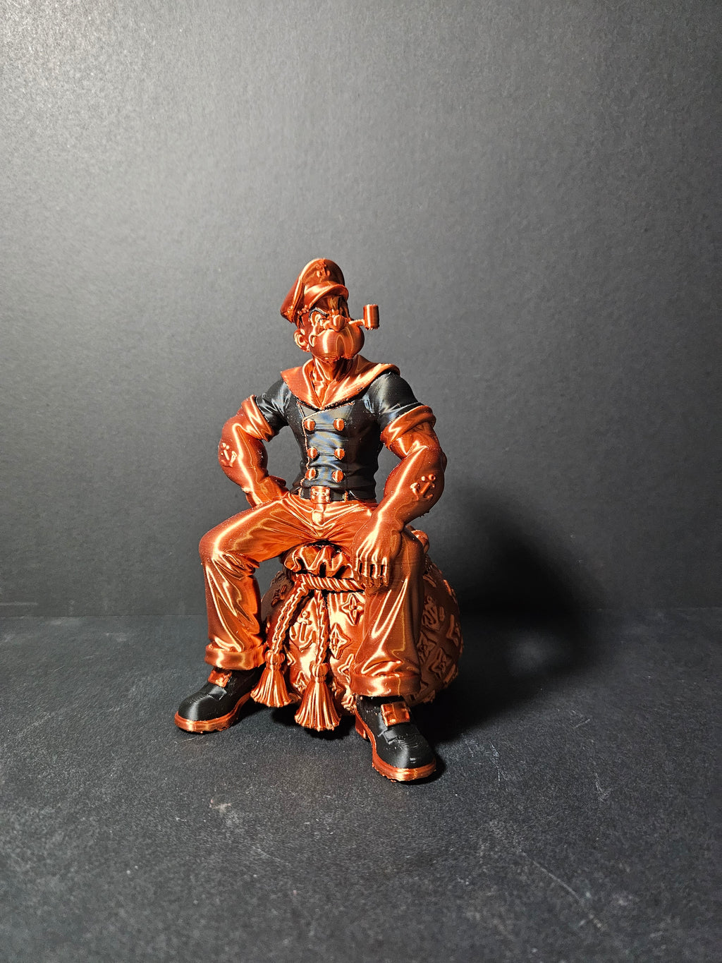 # Heading  Designer Popeye Sculpture – 18cm | Black & Copper Silk | $55