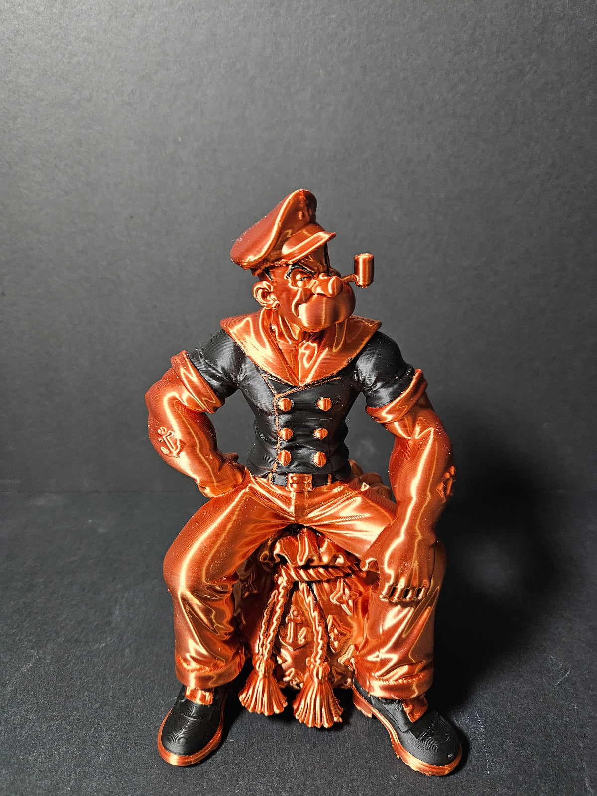 # Heading  Designer Popeye Sculpture – 18cm | Black & Copper Silk | $55