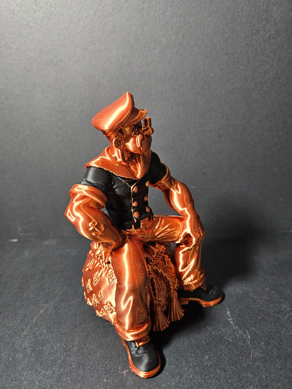 # Heading  Designer Popeye Sculpture – 18cm | Black & Copper Silk | $55