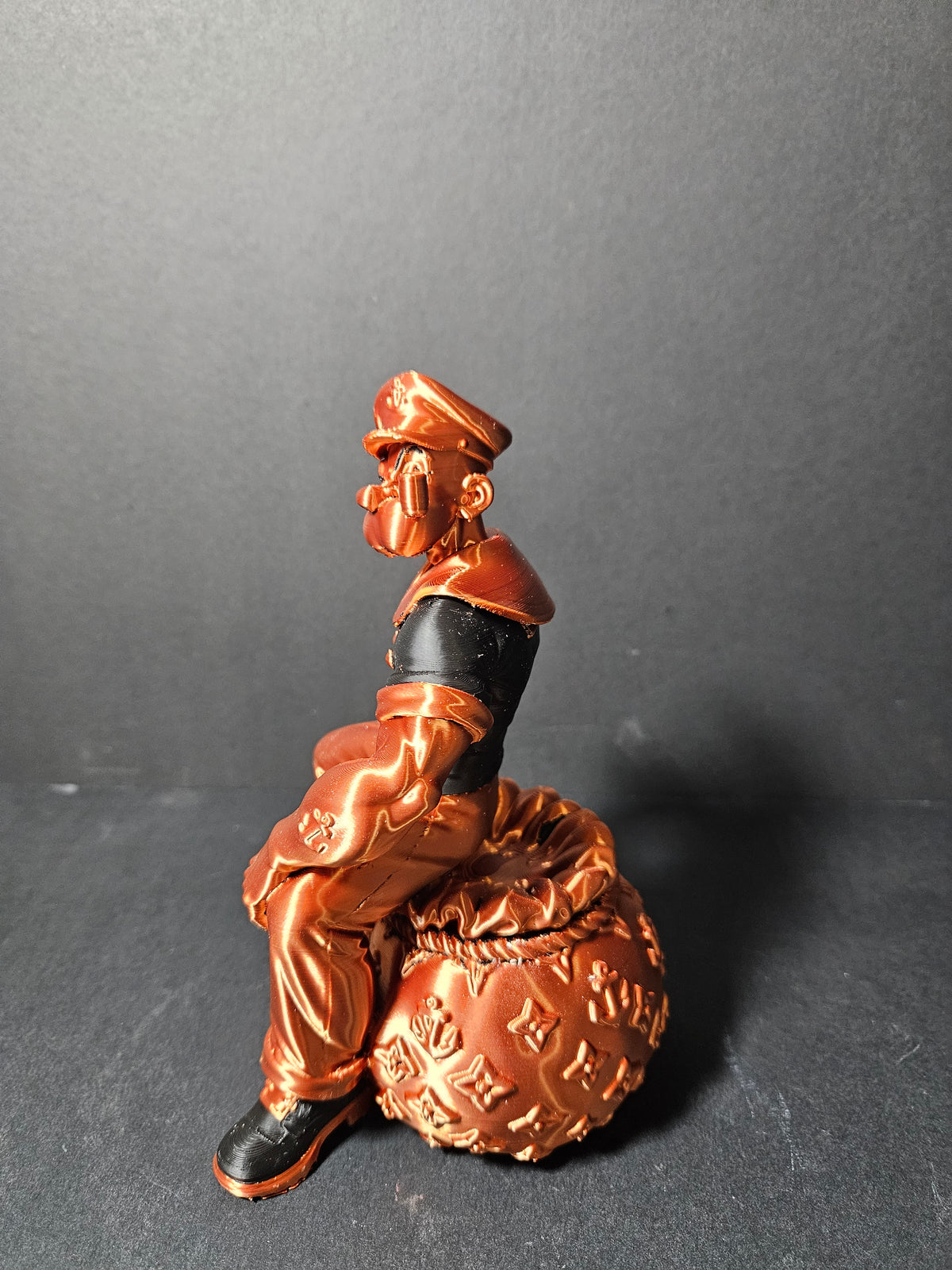 # Heading  Designer Popeye Sculpture – 18cm | Black & Copper Silk | $55