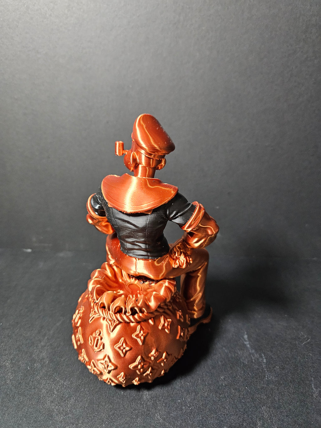# Heading  Designer Popeye Sculpture – 18cm | Black & Copper Silk | $55