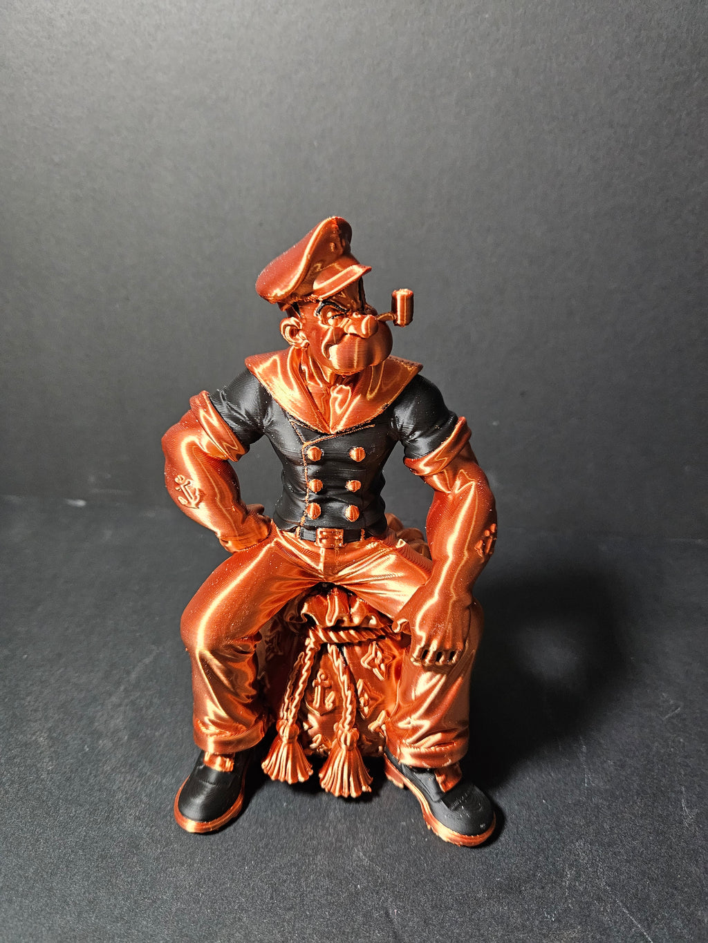 # Heading  Designer Popeye Sculpture – 18cm | Black & Copper Silk | $55