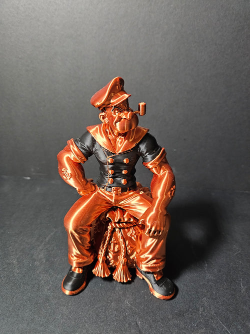 # Heading  Designer Popeye Sculpture – 18cm | Black & Copper Silk | $55