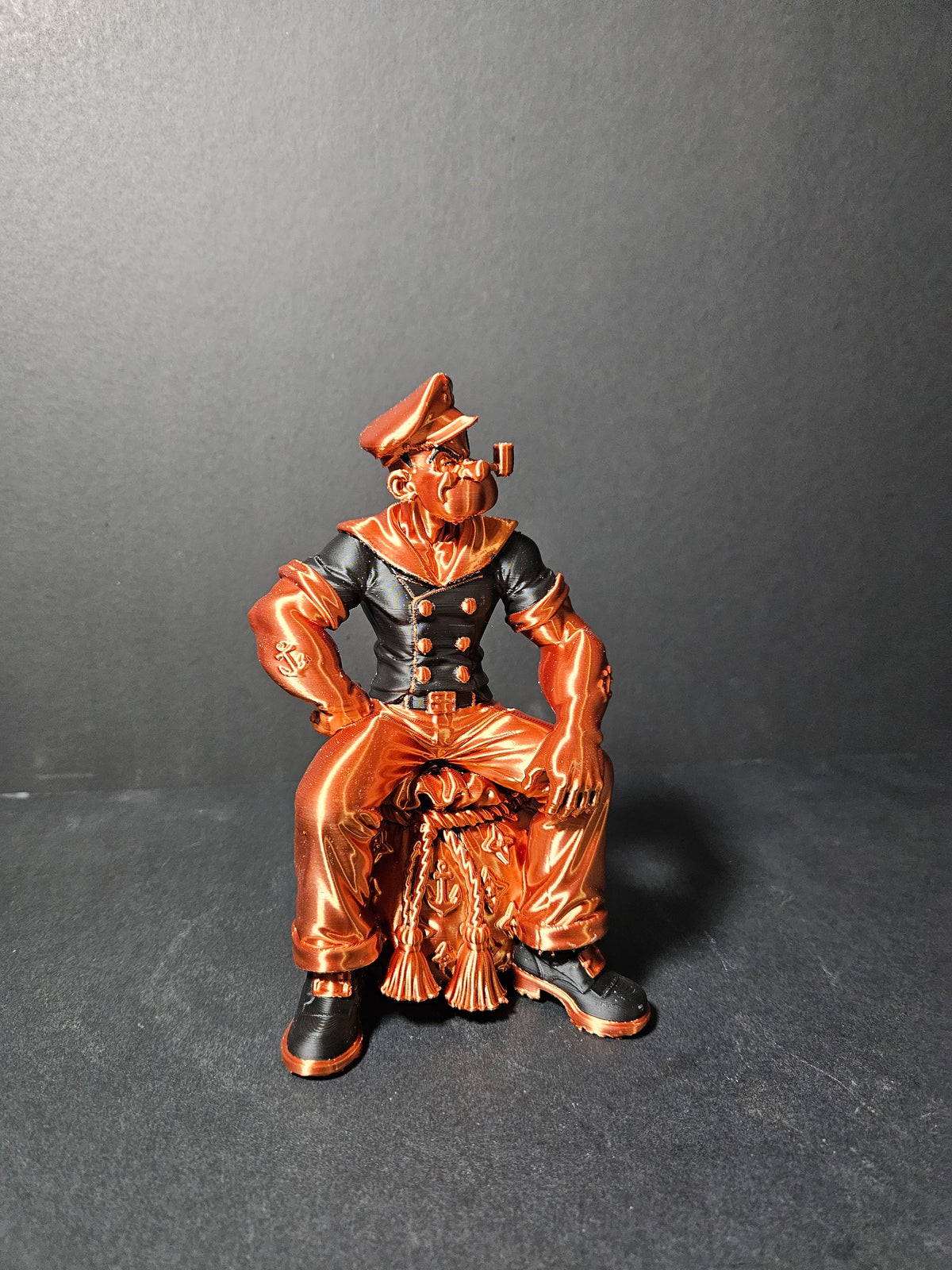 # Heading  Designer Popeye Sculpture – 18cm | Black & Copper Silk | $55